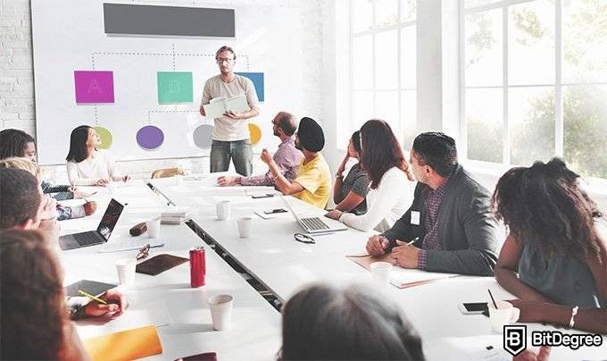 Alison online courses: people in a conference room.